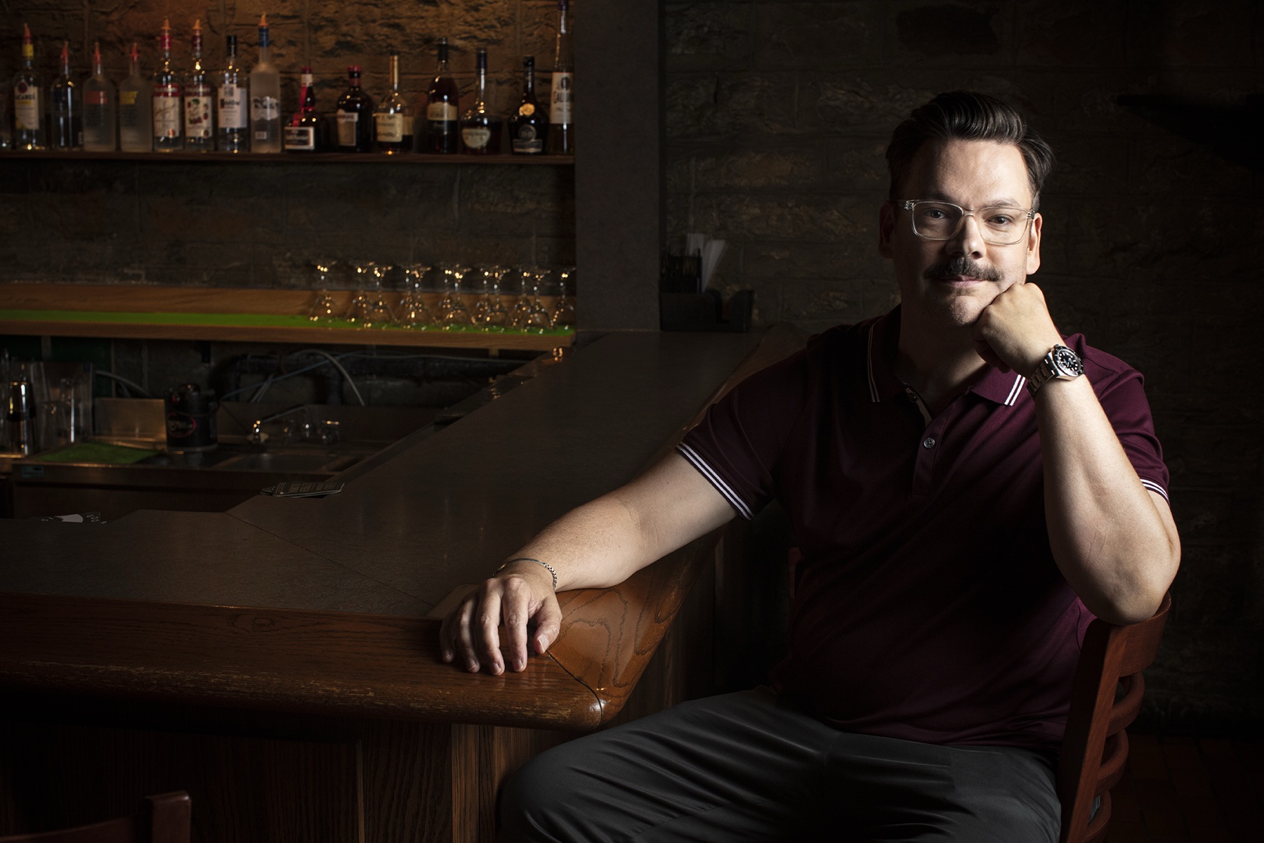 Derek seated at a bar